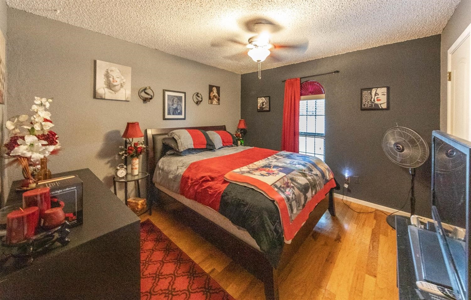 5722 2nd Place Lubbock, TX 79416 - Photo 8 of 21 a bedroom with a bed and a chandelier