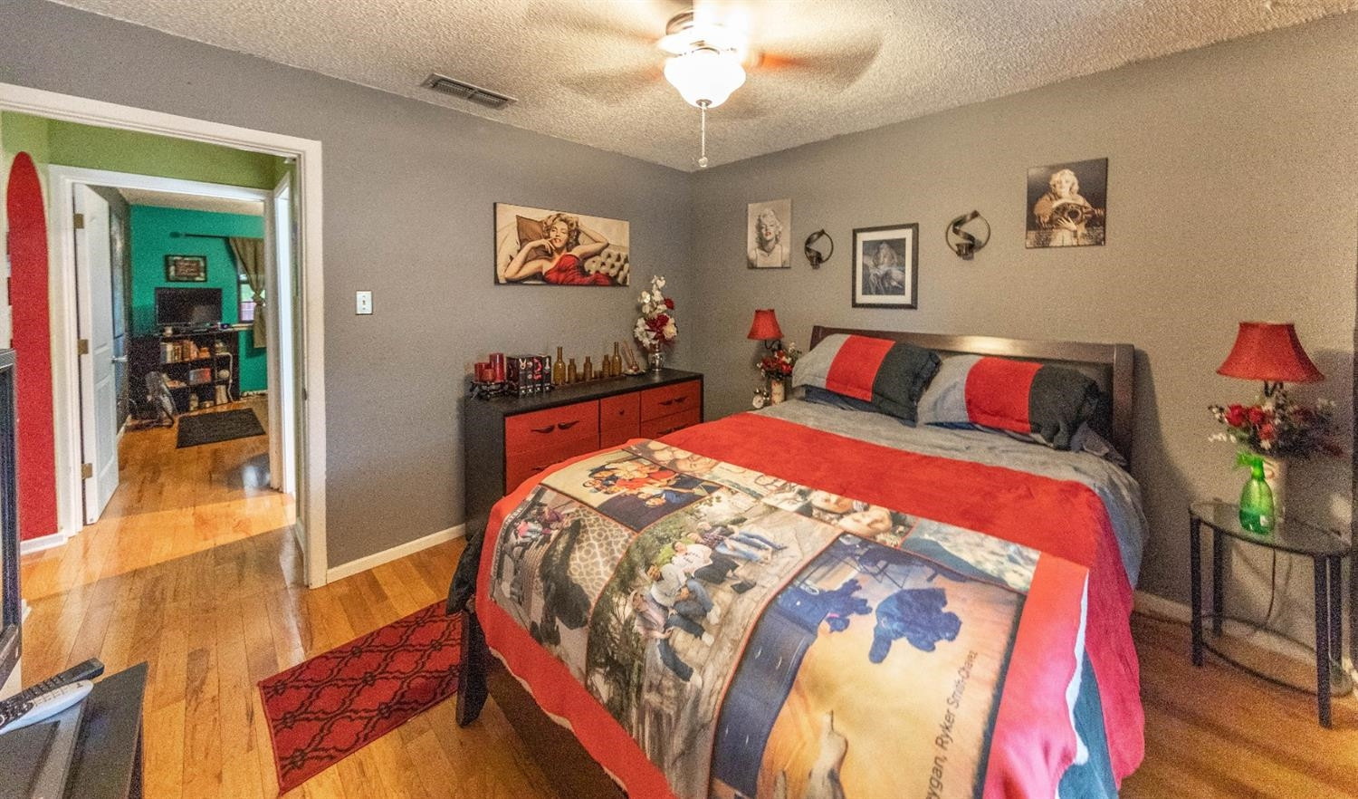 5722 2nd Place Lubbock, TX 79416 - Photo 9 of 21 a bedroom with bed and paintings on wall