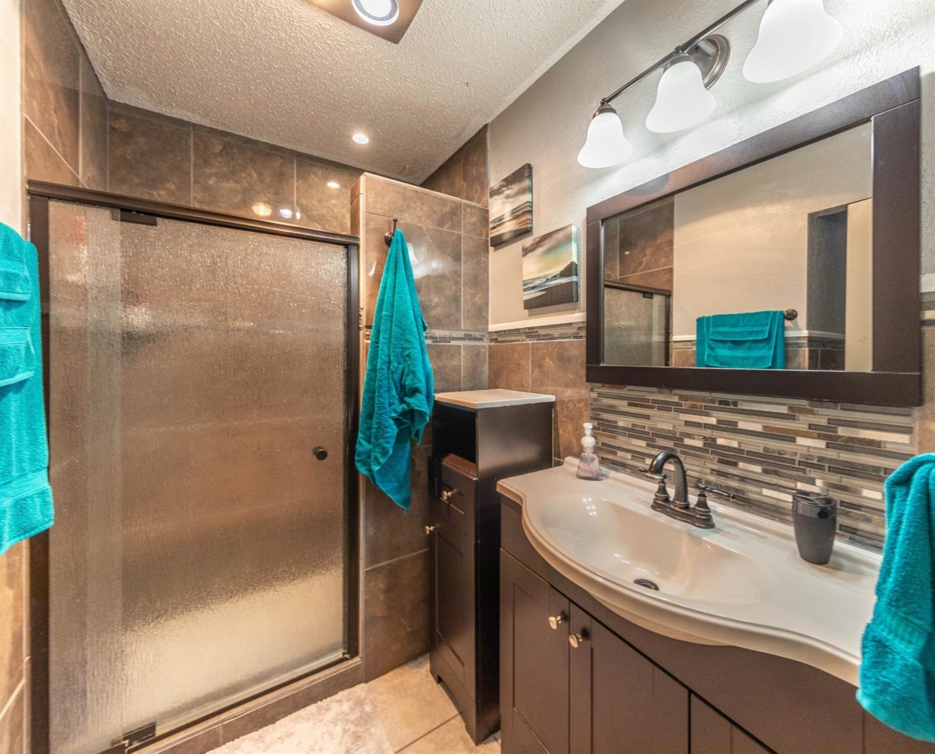 5722 2nd Place Lubbock, TX 79416 - Photo 10 of 21 a bathroom with a sink and a mirror