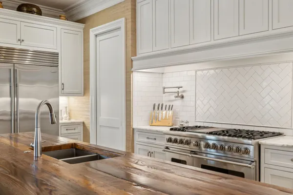 a large kitchen with a counter space a sink and appliances