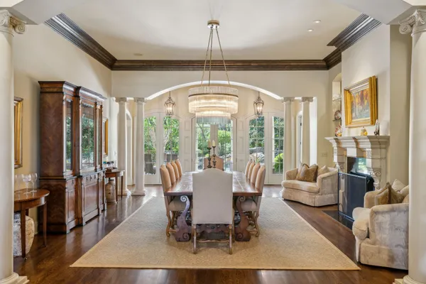 a living room with furniture a fireplace and a chandelier