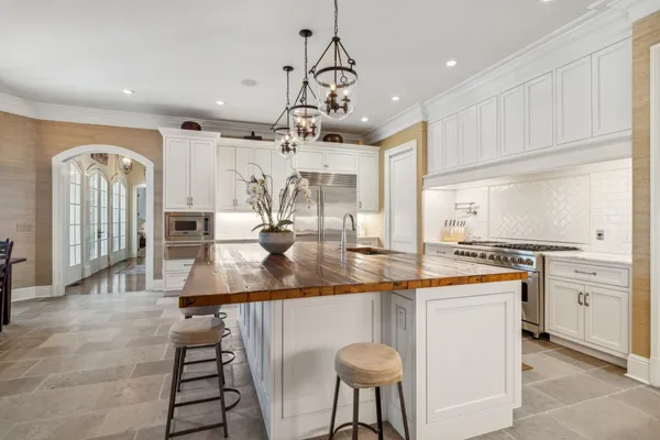 a view of a kitchen with stainless steel appliances granite countertop a sink and a stove