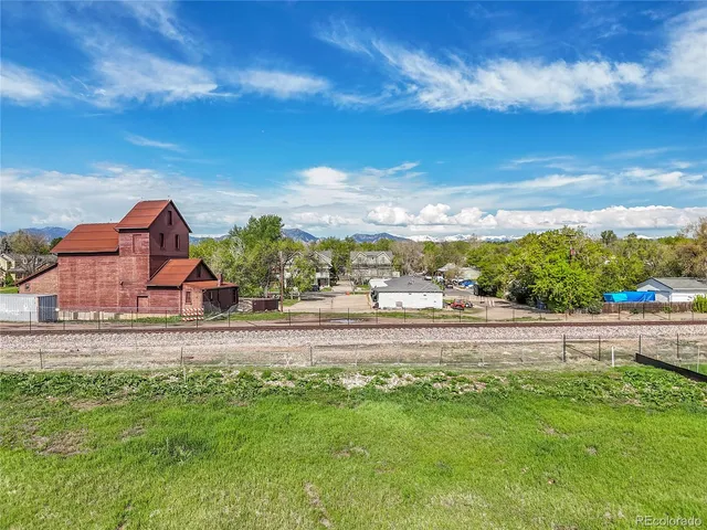 front view of house with yard and mountain in the background