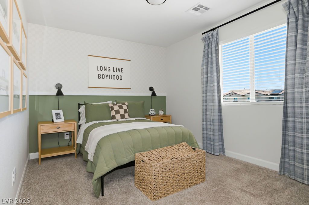 913 Cadence View Way Henderson, NV 89011 - Photo 37 of 46 A comforting bedroom features a full bed, nightstands, and soft carpeting.