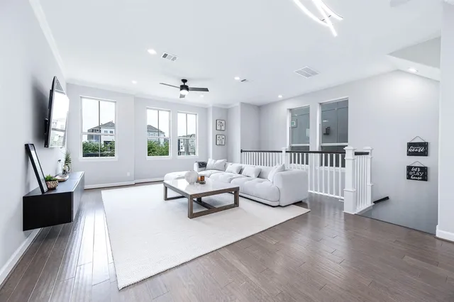 a living room with furniture and wooden floor