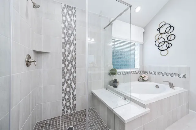 a bathroom with a bathtub a shower and a sink