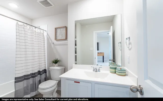 a bathroom with a sink toilet mirror and shower
