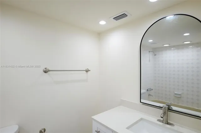 a bathroom with a sink and mirror