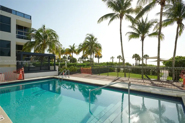 a view of a swimming pool with a table and chairs