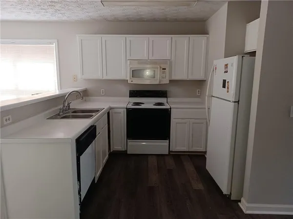 a kitchen with a sink stove and refrigerator