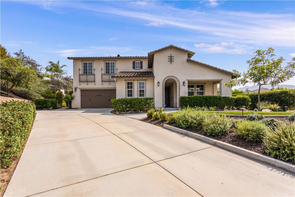 a view of house with outdoor space garden and tall tree