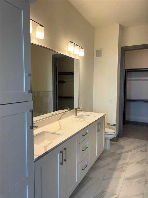 2700 Old Denton Road, Unit 4440 Carrollton, TX 75007 - Photo 5 of 16 a bathroom with a granite countertop sink and a mirror