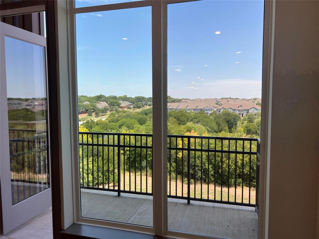 2700 Old Denton Road, Unit 4440 Carrollton, TX 75007 - Photo 6 of 16 a view of a glass door and a balcony