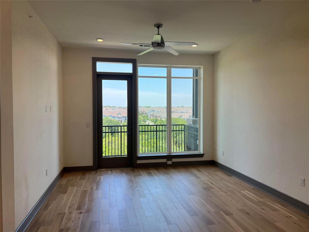 2700 Old Denton Road, Unit 4440 Carrollton, TX 75007 - Photo 7 of 16 an empty room with wooden floor and a window