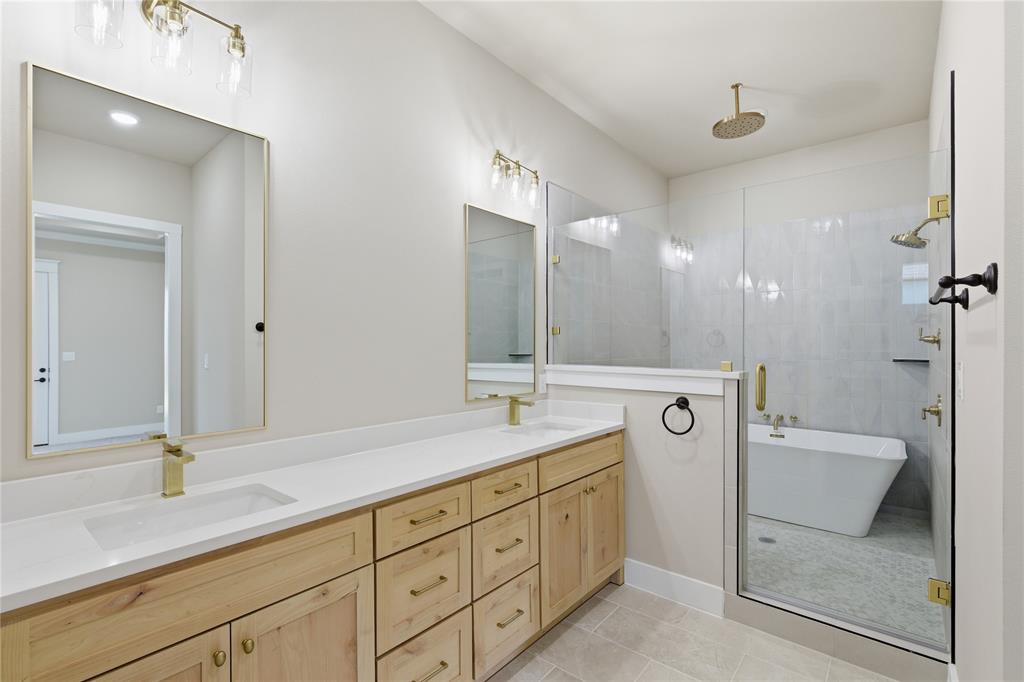 709 Anne Road Van Alstyne, TX 75495 - Photo 20 of 28 Double vanity with light wood cabinetry and white countertops