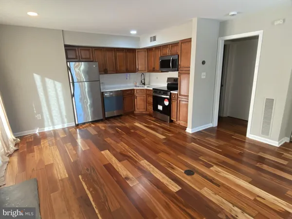 a kitchen with stainless steel appliances granite countertop a refrigerator sink and cabinets