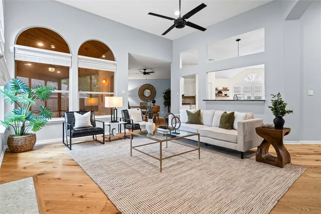 a living room with furniture and wooden floor
