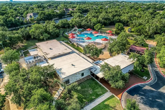 an aerial view of a house with a swimming pool a yard and outdoor seating
