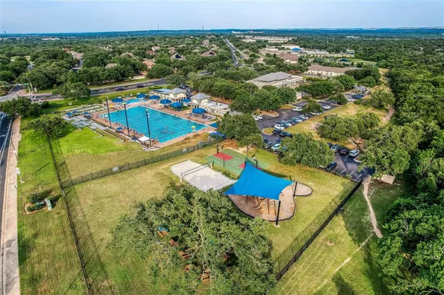 an aerial view of a house with a swimming pool