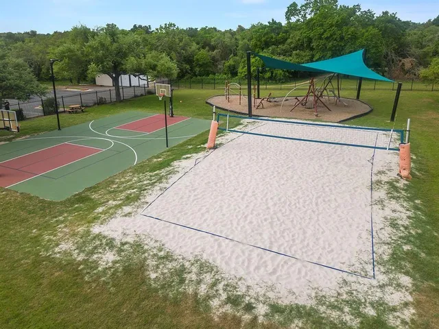 a view of a park with iron fence