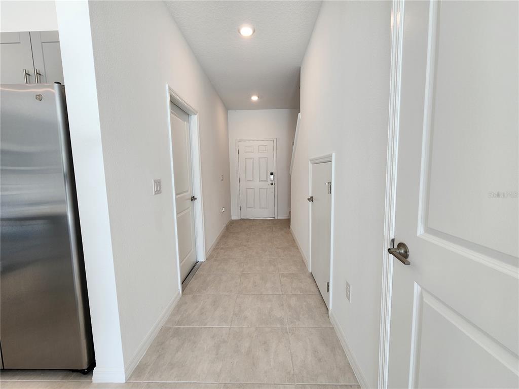 2620 Penguin Boulevard Davenport, FL 33837 - Photo 8 of 14 a view of a hallway with wooden floor and staircase