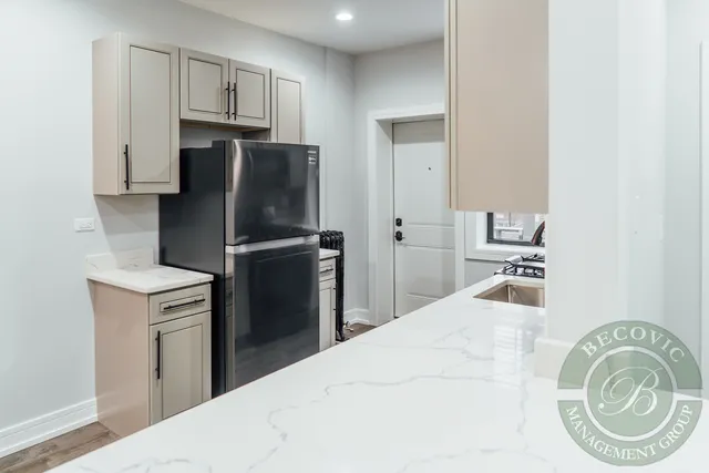 a kitchen with a refrigerator and a sink