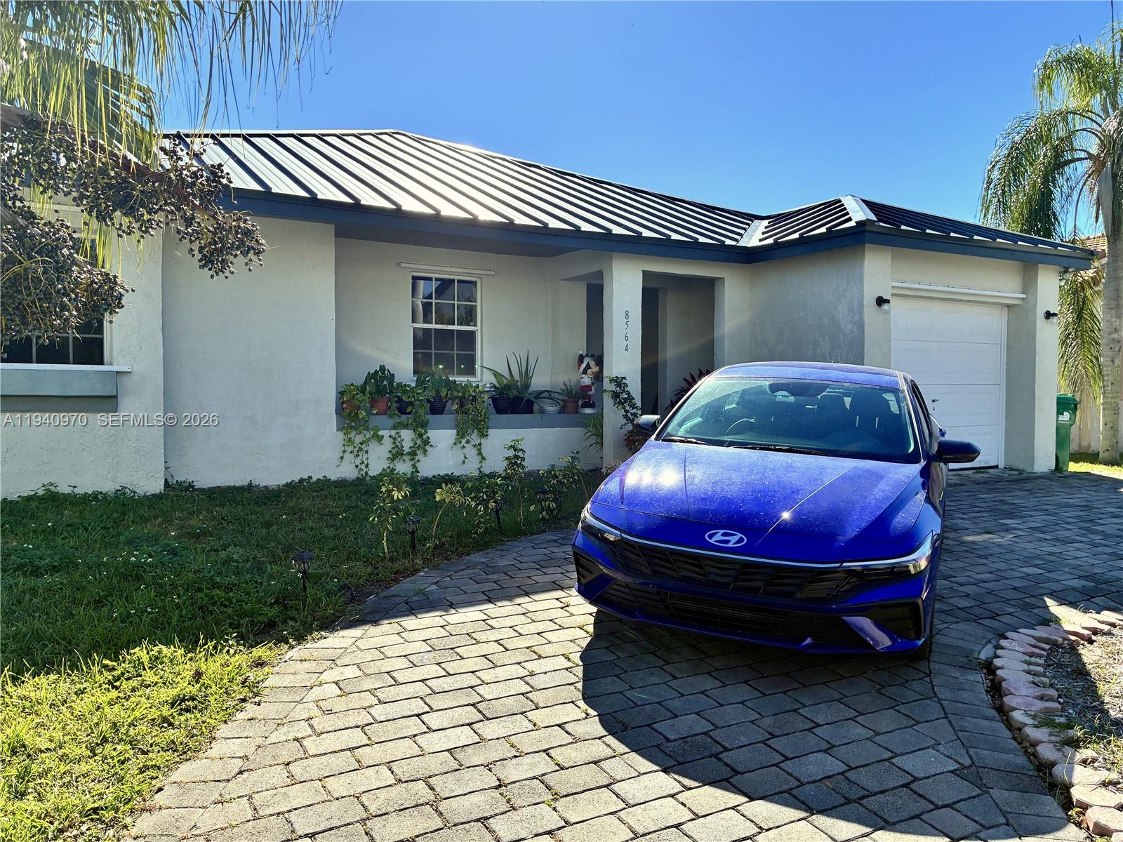 8564 Southwest 210th Terrace Cutler Bay, FL 33189 - Photo 1 of 18 a house view with a garden space