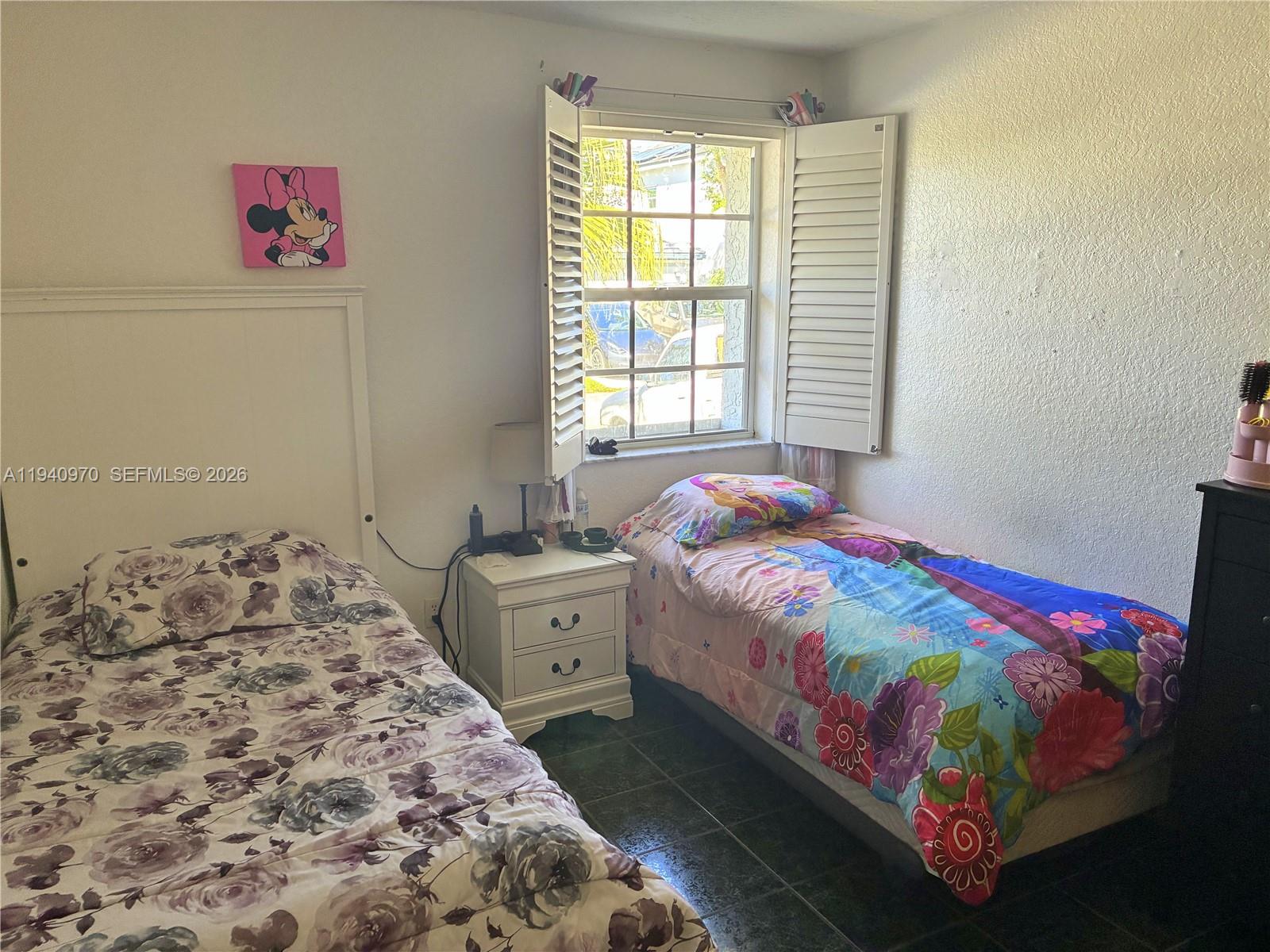 8564 Southwest 210th Terrace Cutler Bay, FL 33189 - Photo 11 of 18 a bedroom with a bed and a window