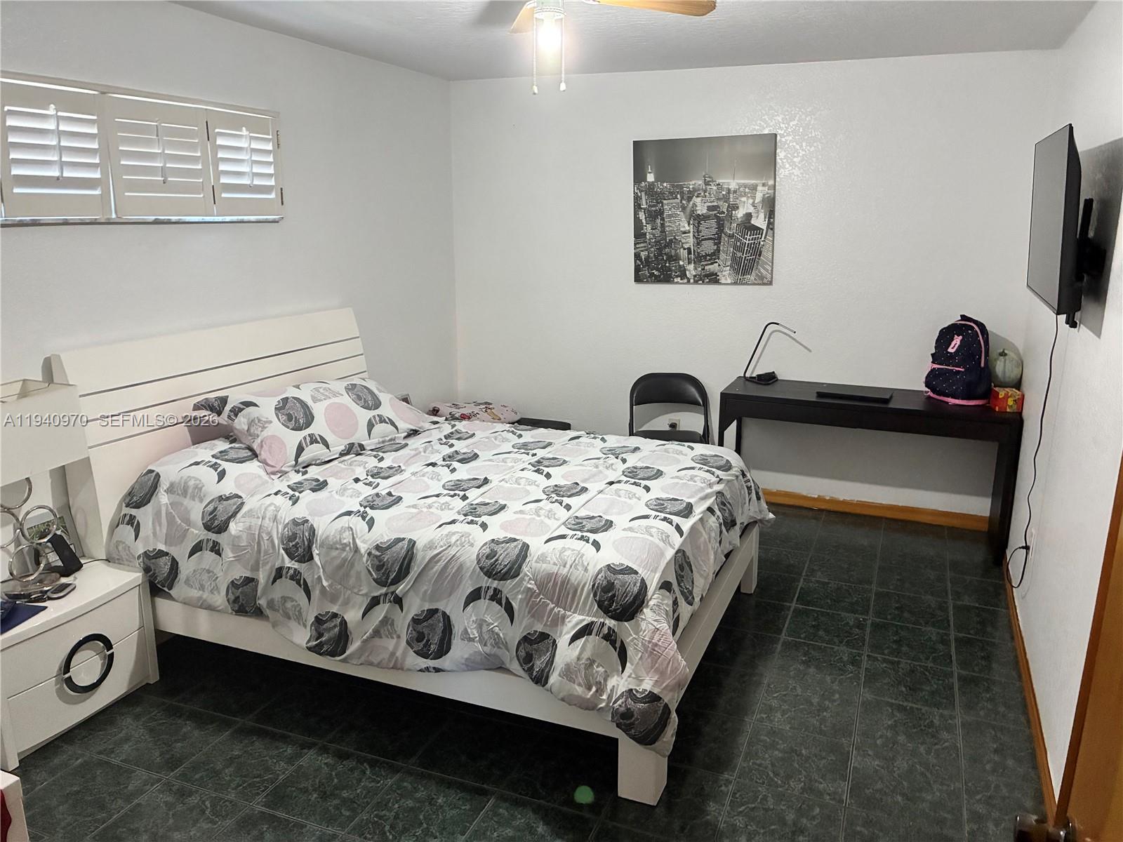 8564 Southwest 210th Terrace Cutler Bay, FL 33189 - Photo 15 of 18 a bedroom with a bed and a flat screen tv