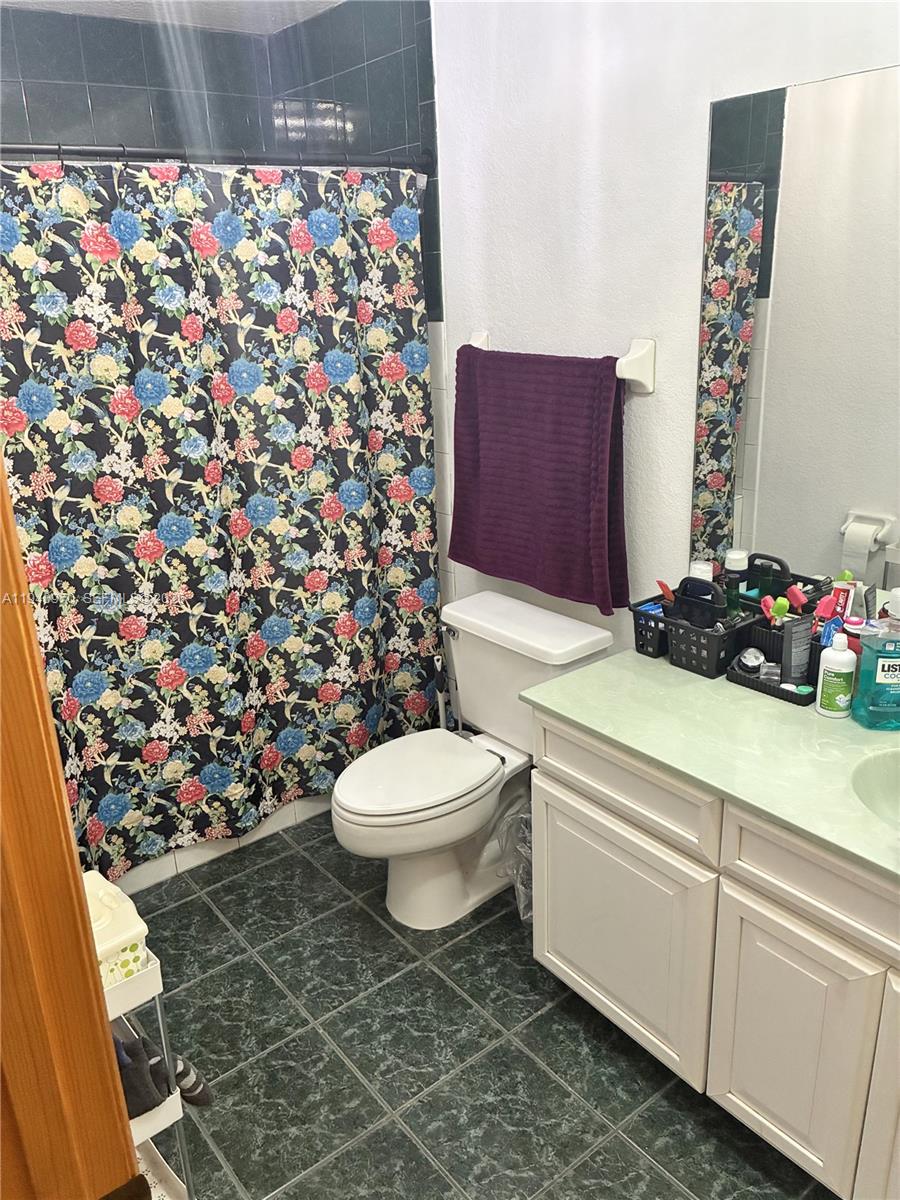 8564 Southwest 210th Terrace Cutler Bay, FL 33189 - Photo 16 of 18 a bathroom with a sink toilet and shower