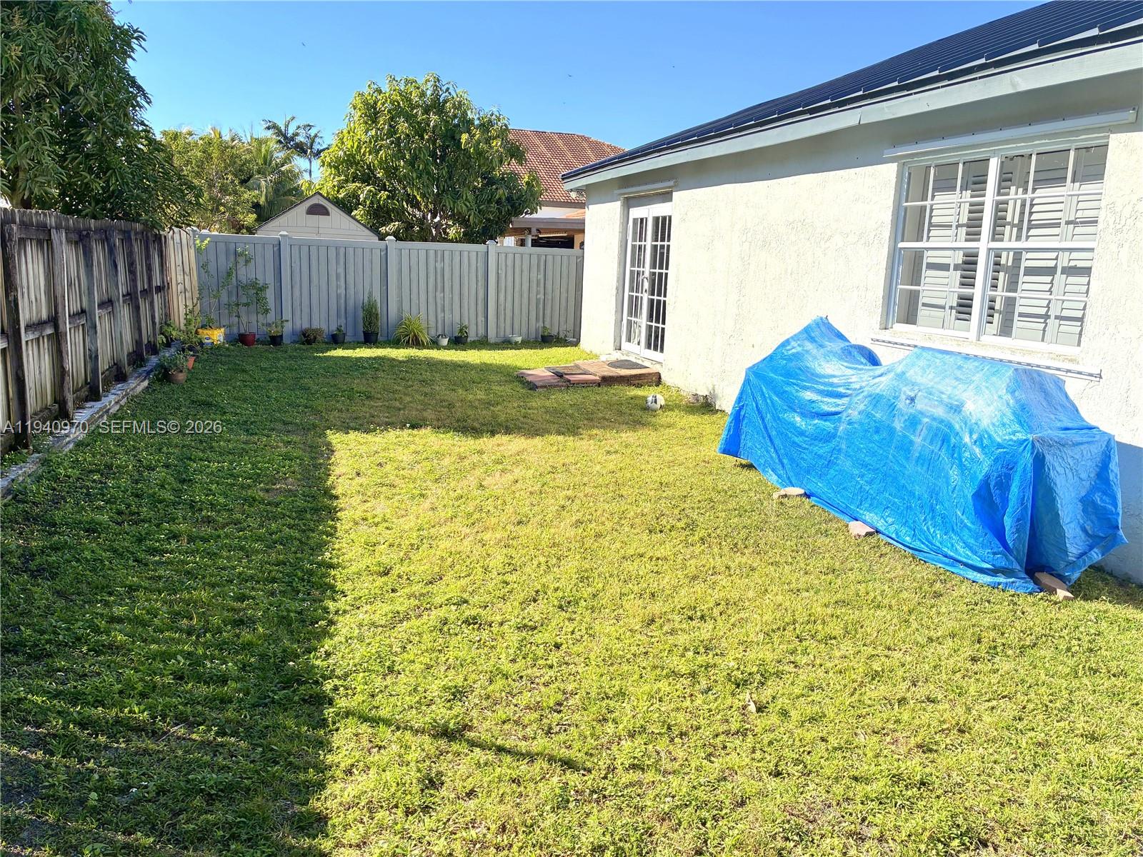 8564 Southwest 210th Terrace Cutler Bay, FL 33189 - Photo 17 of 18 a view of a backyard with a small pool