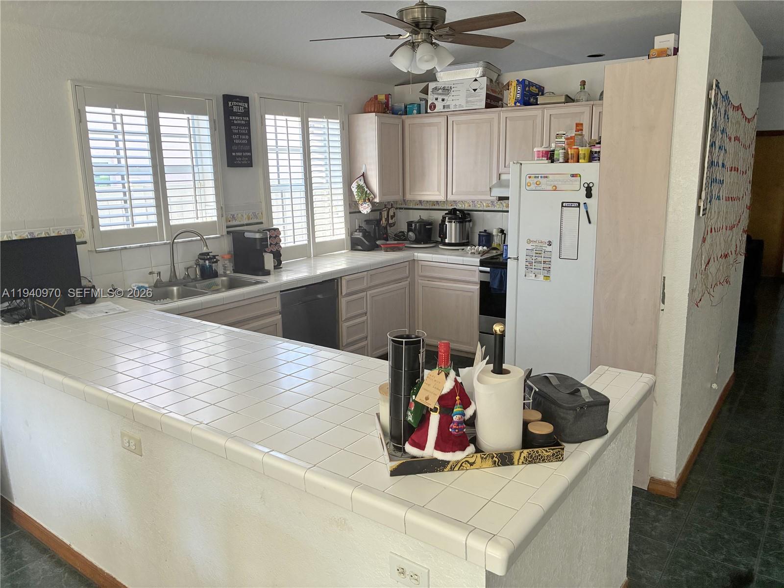 8564 Southwest 210th Terrace Cutler Bay, FL 33189 - Photo 6 of 18 a kitchen with a refrigerator and a sink