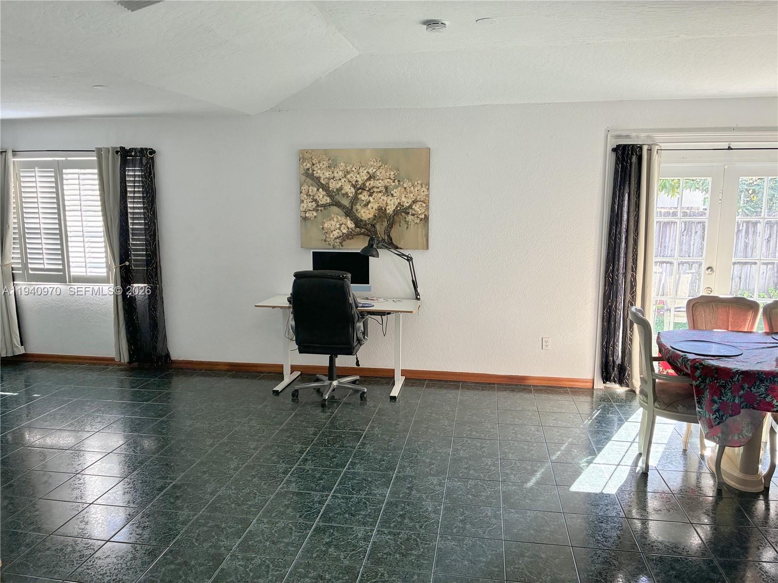 8564 Southwest 210th Terrace Cutler Bay, FL 33189 - Photo 8 of 18 a view of a workspace with furniture and a window