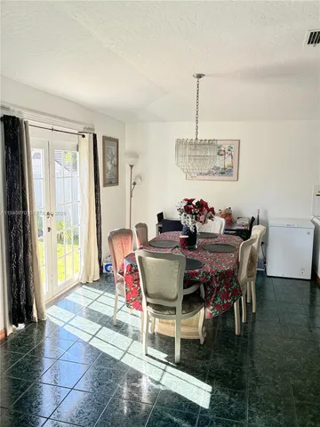 a dining room with furniture window and wooden floor