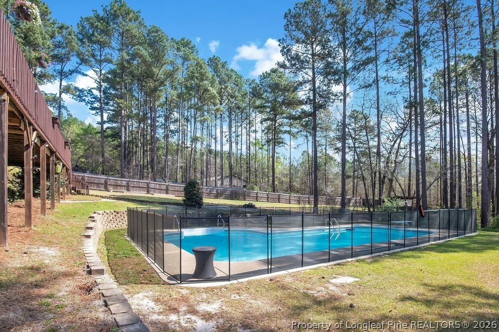 419 Senter Lane Bunnlevel, NC 28323 - Photo 41 of 49 a view of a swimming pool with a backyard and trees