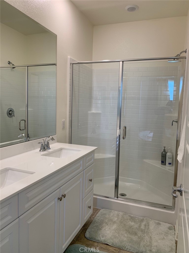 170 Unity Irvine, CA 92614 - Photo 4 of 10 a bathroom with a granite countertop sink mirror and a shower