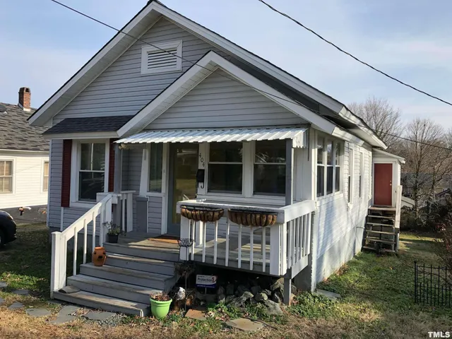 a view of a house with wooden deck front door
