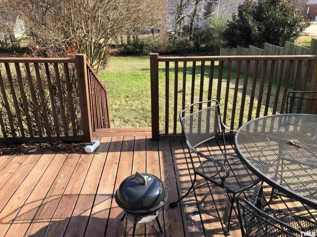 a view of a patio with table and chairs and wooden floor