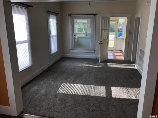 a kitchen with granite countertop white cabinets and refrigerator