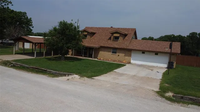 a aerial view of a house with a yard and garage
