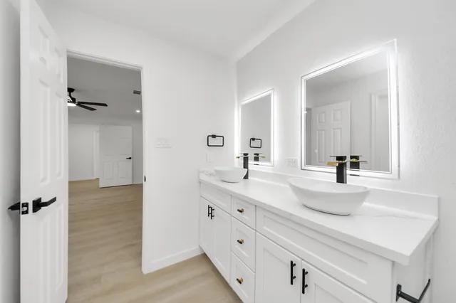a bathroom with a double vanity sink mirror and