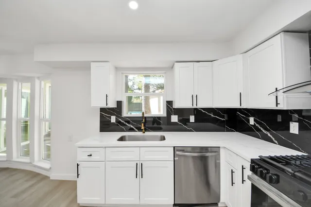 a kitchen with a sink and cabinets