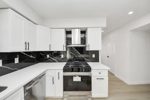 a kitchen with a stove and a sink