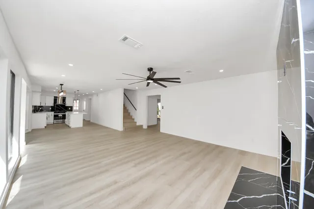 a view of a kitchen with a sink and a refrigerator