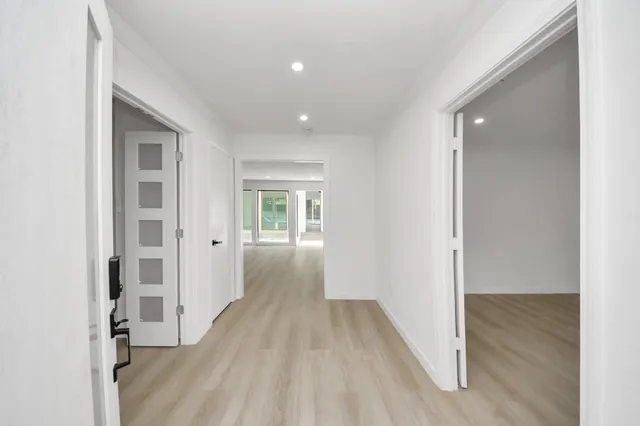 a view of a hallway with wooden floor