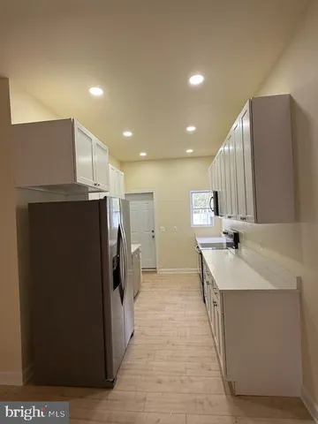 a kitchen with stainless steel appliances a refrigerator and a sink