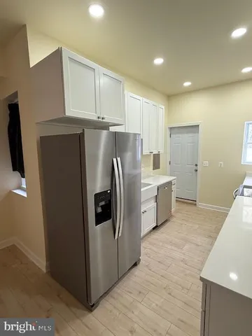 a kitchen with stainless steel appliances a refrigerator and a sink