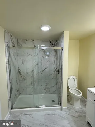 a bathroom with a shower toilet and sink