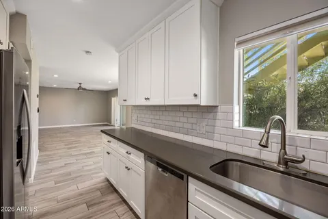 a kitchen with a sink and cabinets