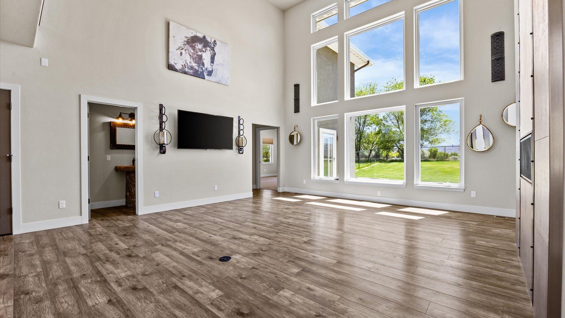 2041 J J 1/2 Road Fruita, CO 81521 - Photo 5 of 42 a view of empty room with wooden floor and fan
